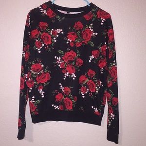 Black sweater, covered in red roses.